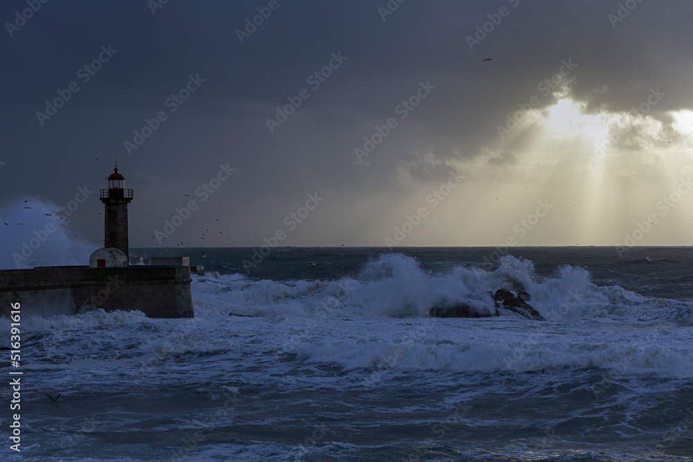 Lighthouse in a stormy sunset