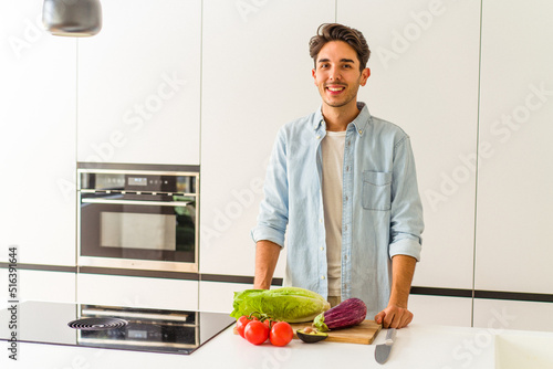 Young mixed race man preparing a salad for lunch