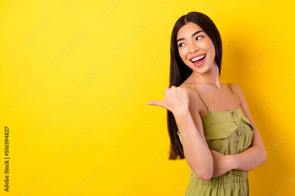 Profile photo of lovely pretty filipino lady look direct thumb finger empty space isolated on yellow color background Profile photo of lovely pretty filipino lady look direct thumb finger empty space isolated on yellow color background