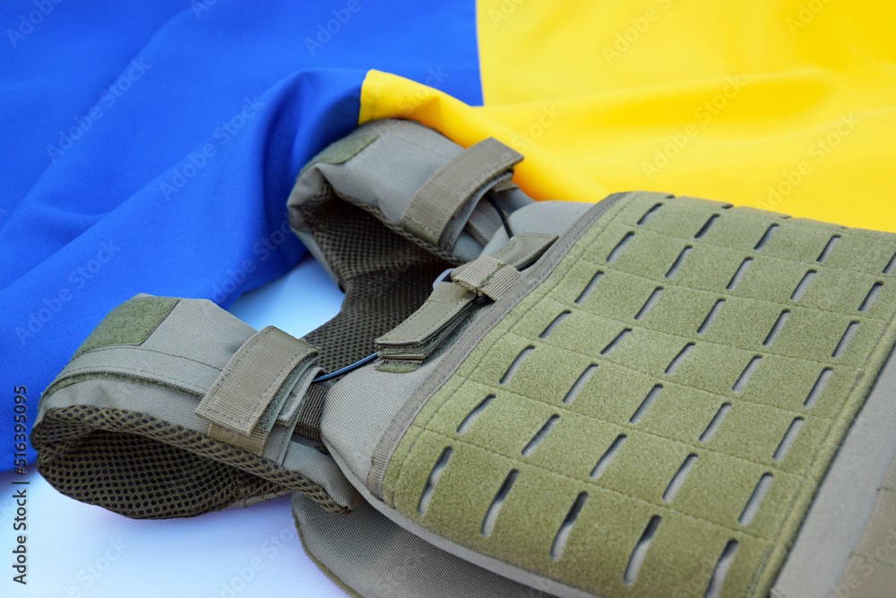 Tactical, military body armor with plates on the background of the flag