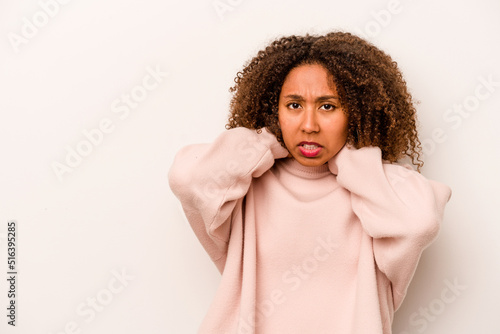 Young African American woman isolated on white background touching back of head, thinking and making a choice. © Asier
