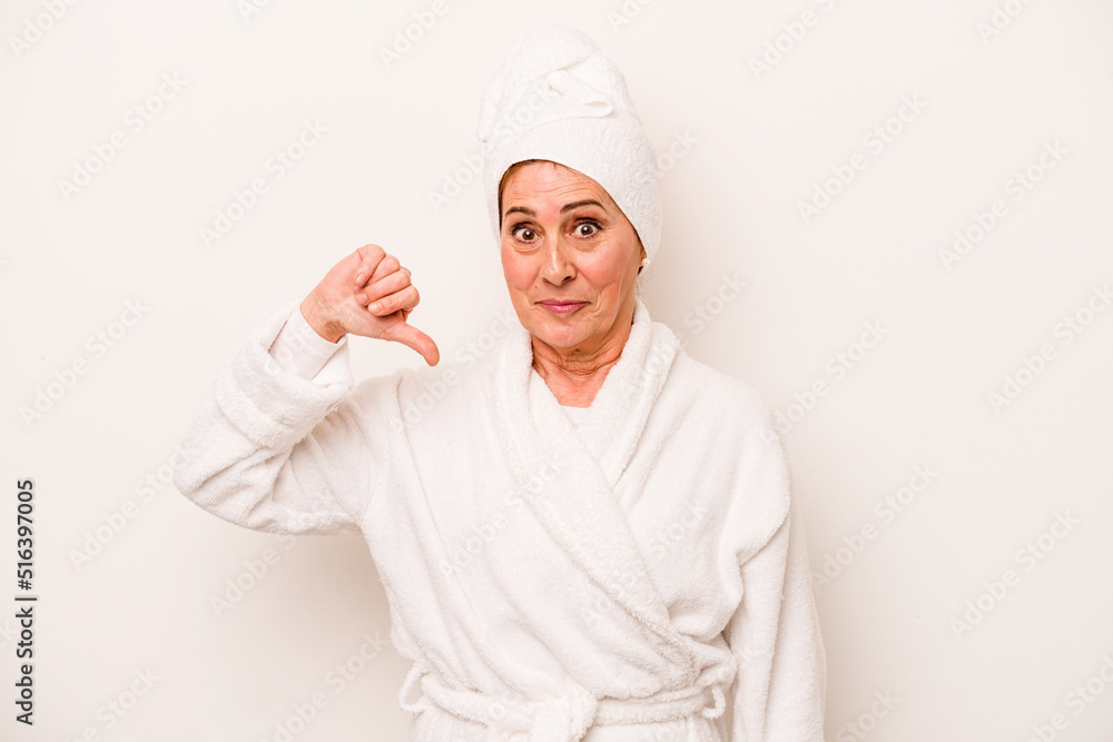 Middle age caucasian woman wearing a bathrobe isolated on white background showing a dislike gesture, thumbs down. Disagreement concept.