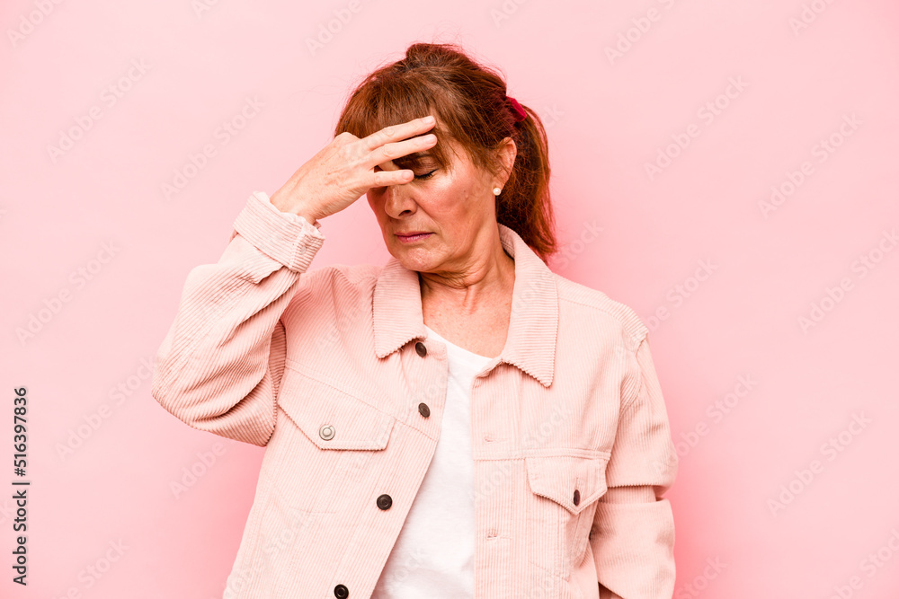 Middle age caucasian woman isolated on pink background having a head ache, touching front of the face. Middle age caucasian woman isolated on pink background having a head ache, touching front of the face.