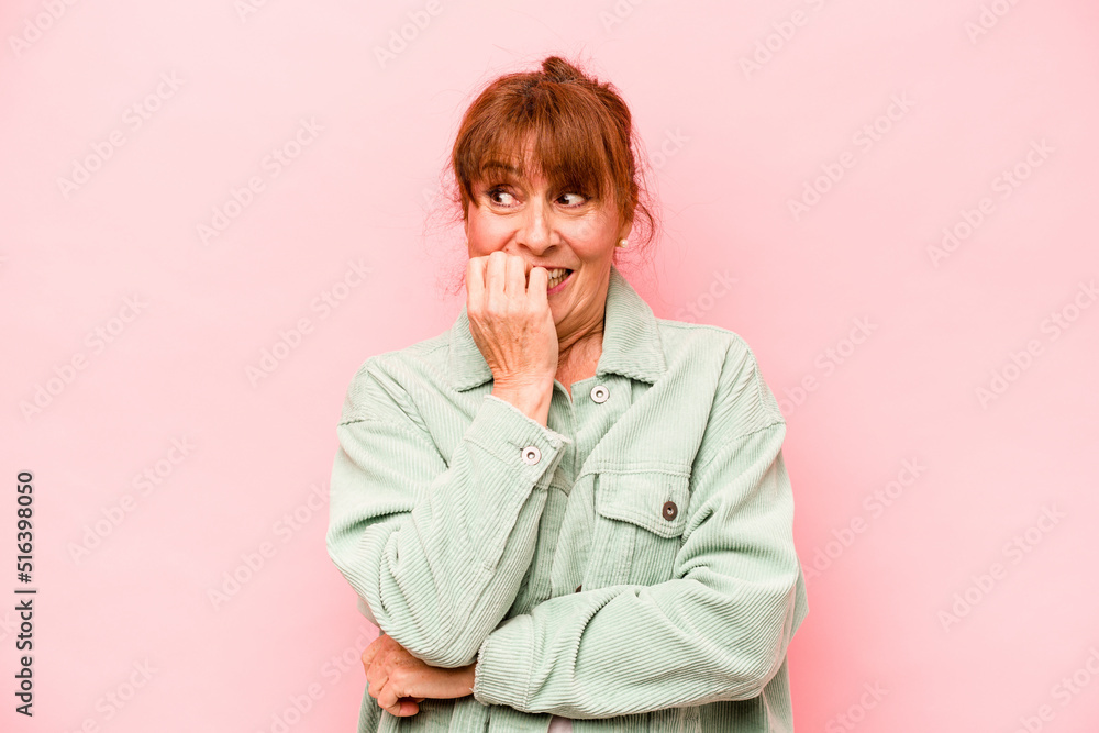 Middle age caucasian woman isolated on pink background biting fingernails, nervous and very anxious. Middle age caucasian woman isolated on pink background biting fingernails, nervous and very anxious.