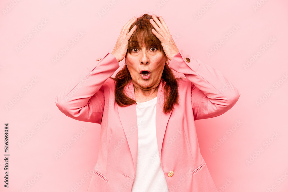 Middle age caucasian woman isolated on pink background being shocked, she has remembered important meeting. Middle age caucasian woman isolated on pink background being shocked, she has remembered important meeting.