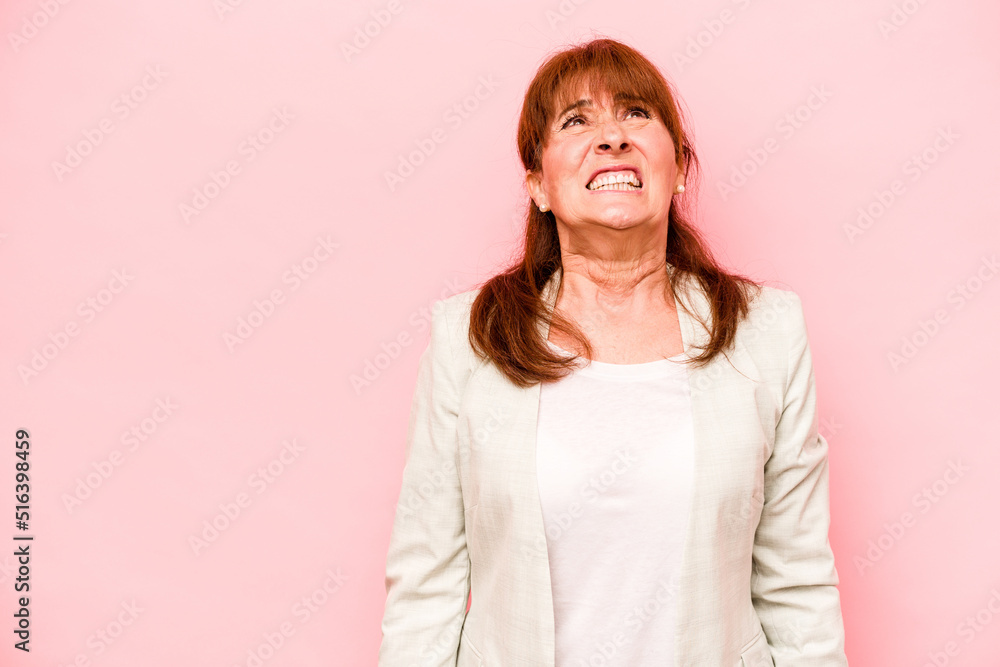 Middle age caucasian woman isolated on pink background shouting very angry, rage concept, frustrated. Middle age caucasian woman isolated on pink background shouting very angry, rage concept, frustrated.