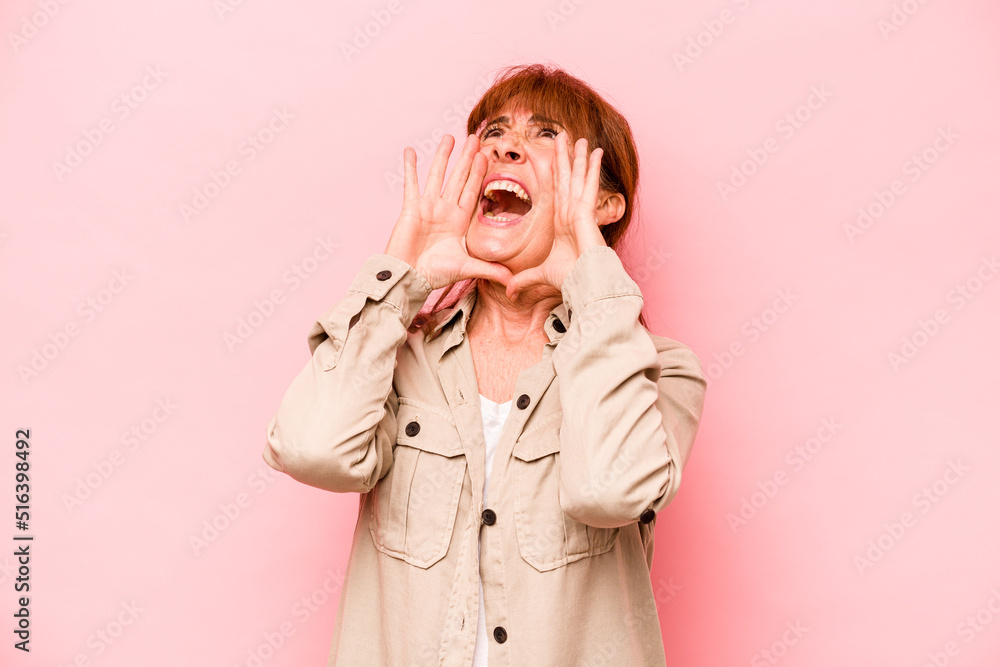 Middle age caucasian woman isolated on pink background shouting excited to front. Middle age caucasian woman isolated on pink background shouting excited to front.