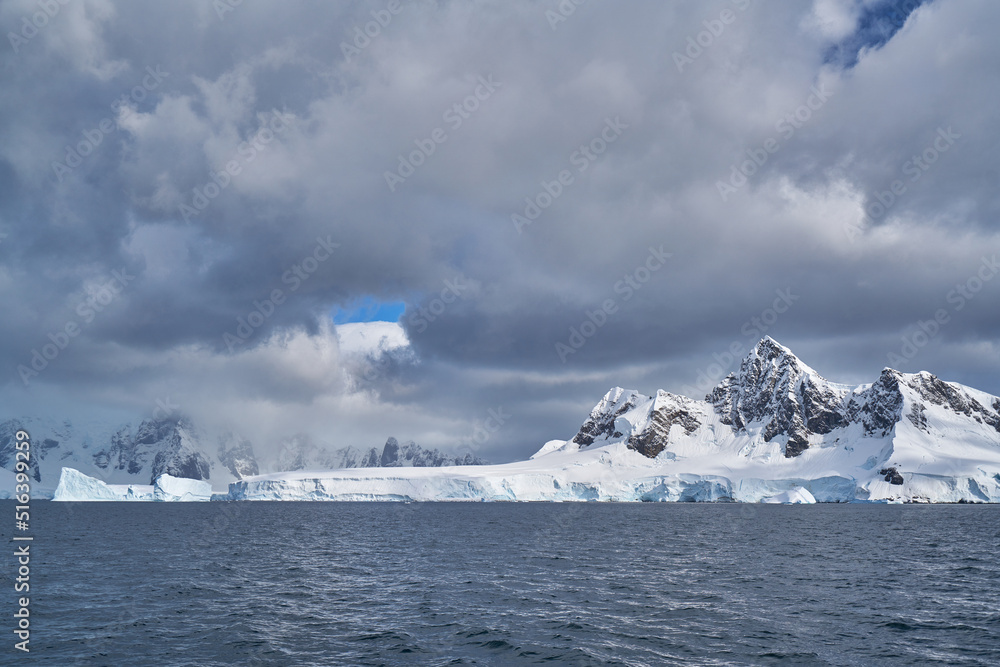 Antartic landscapes during a tripo across the Antartic peninsula with lot of icebergs, mountains and glaciers which land on the sea Antartic landscapes during a tripo across the Antartic peninsula with lot of icebergs, mountains and glaciers which land on the sea
