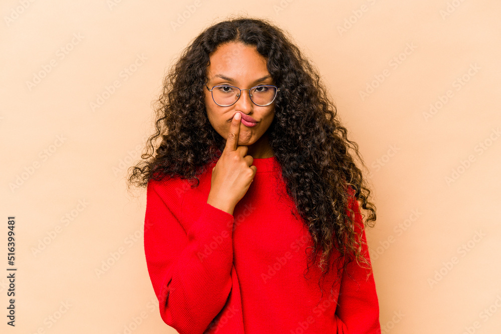 Young hispanic woman isolated on beige background thinking and looking up, being reflective, contemplating, having a fantasy. Young hispanic woman isolated on beige background thinking and looking up, being reflective, contemplating, having a fantasy.