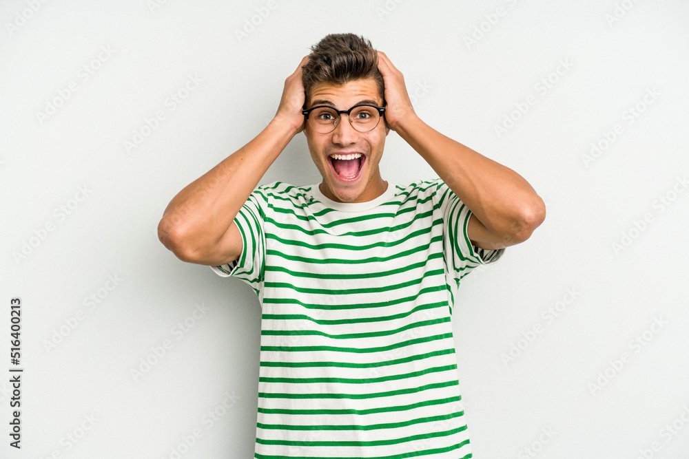 Young caucasian man isolated on white background screaming, very excited, passionate, satisfied with something. Young caucasian man isolated on white background screaming, very excited, passionate, satisfied with something.