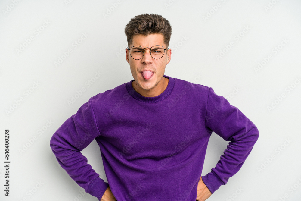 Young caucasian man isolated on white background funny and friendly sticking out tongue. Young caucasian man isolated on white background funny and friendly sticking out tongue.