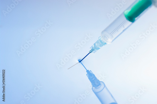 Close up image of a syringe with needle put into water. photo