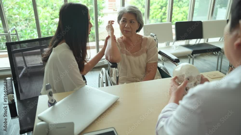 Male doctor diagnosing and describe the abnormalities of the skull of an elderly woman patient in the examination room. Male doctor diagnosing and describe the abnormalities of the skull of an elderly woman patient in the examination room.