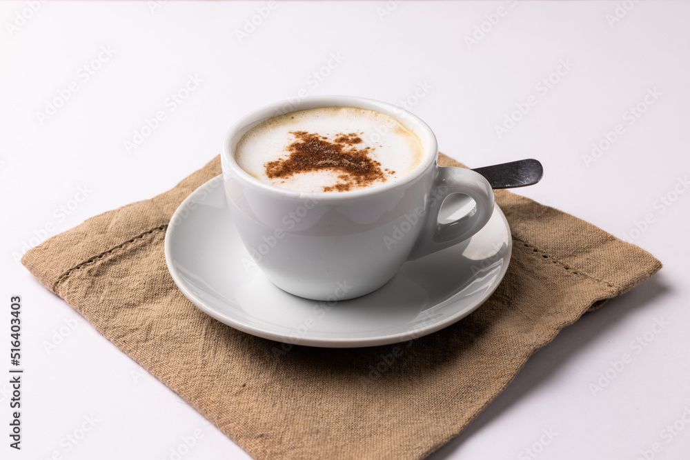 Image of white cup of coffee with milk and tea towel on white background Image of white cup of coffee with milk and tea towel on white background