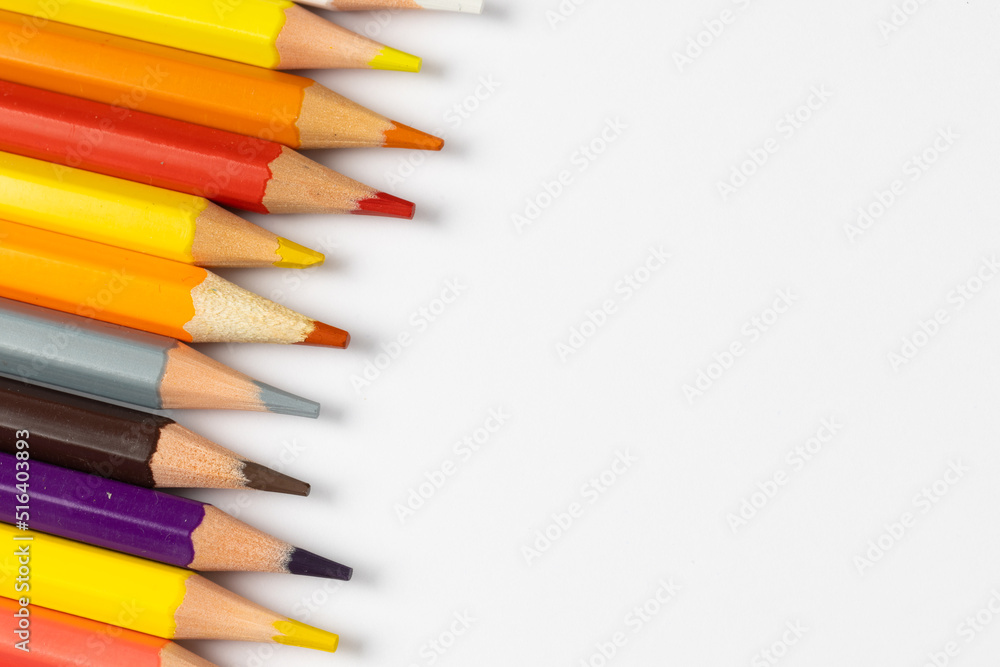 Composition of colorful crayons on white surface with copy space Composition of colorful crayons on white surface with copy space