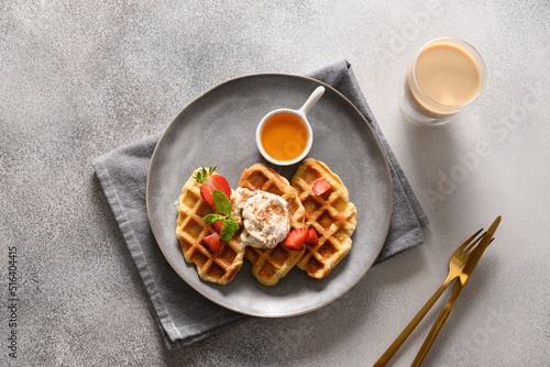 Breakfast with croffles and morning coffee on gray background. Croissant as waffle. View from above. photo