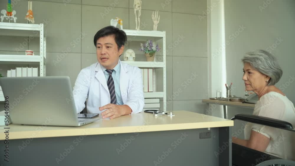 Male doctor asking about symptoms senior female patient wheelchair seat in hospital. Male doctor asking about symptoms senior female patient wheelchair seat in hospital.