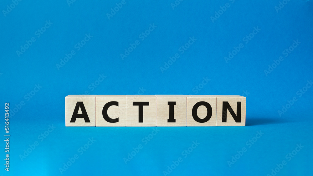 Action symbol. Concept word Action on wooden cubes. Beautiful blue background. Business and Action concept. Copy space. Action symbol. Concept word Action on wooden cubes. Beautiful blue background. Business and Action concept. Copy space.