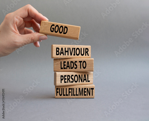 Good behaviour leads to personal fulfillment symbol. Business Concept words Good behaviour leads to personal fulfillment on wooden blocks. Beautiful grey background. Businessman hand. Copy space