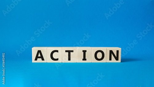 Action symbol. Concept word Action on wooden cubes. Beautiful blue background. Business and Action concept. Copy space.