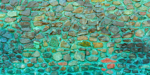 Abstract background of a multi-colored stone wall.