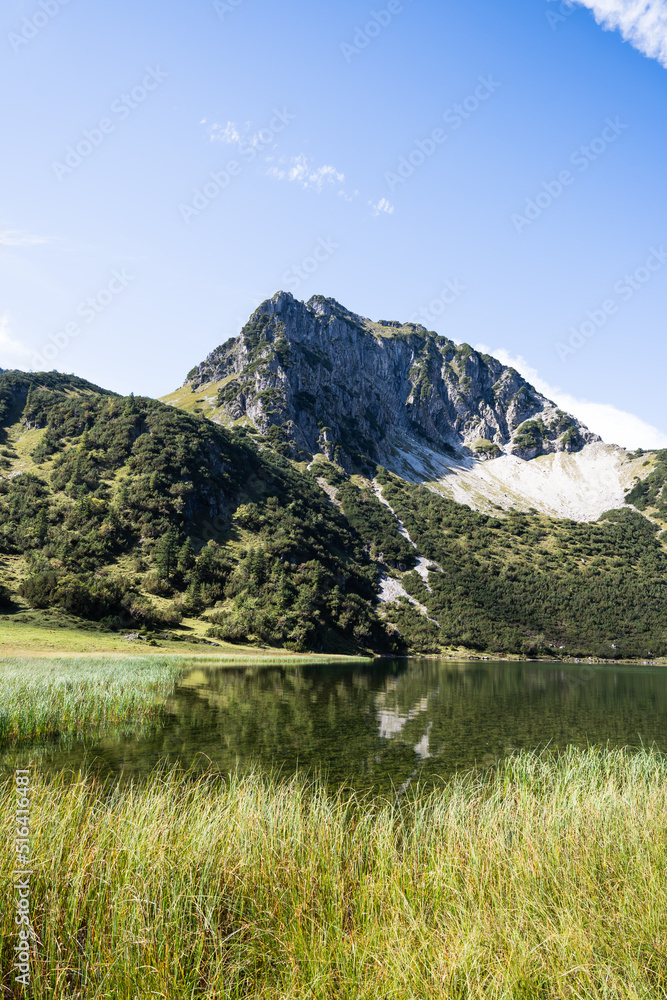 View over a romantic lake in the Alps with Rubihorn in background