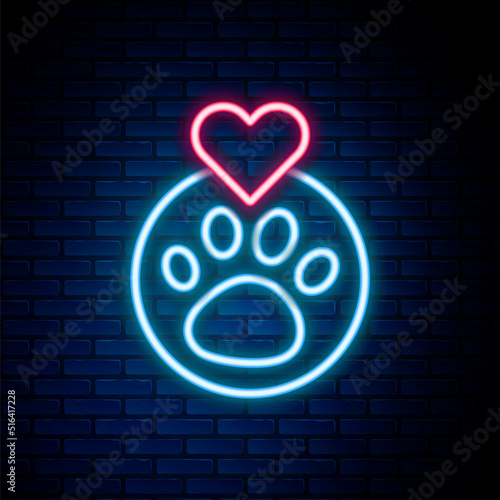Glowing neon line Heart with animals footprint icon isolated on brick wall background. Pet paw in heart. Love to the animals. Colorful outline concept. Vector