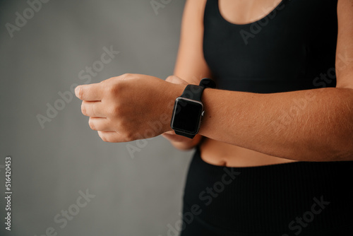 Close up young Caucasian female adjusting her smart watch © Prins Productions
