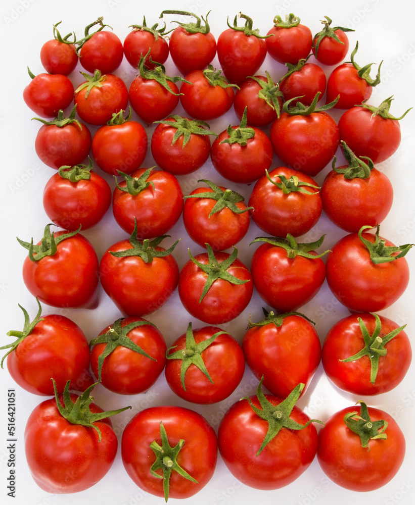 Photo of a ripe tomato on a white background.  Print for printing on tablecloths, napkins, household goods and product packaging design for tomato juice, pasta, snacks.  Banner, signboard 