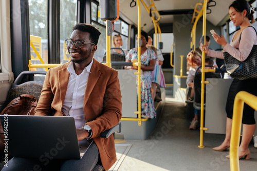 Valokuva Young african american man working on laptop in bus