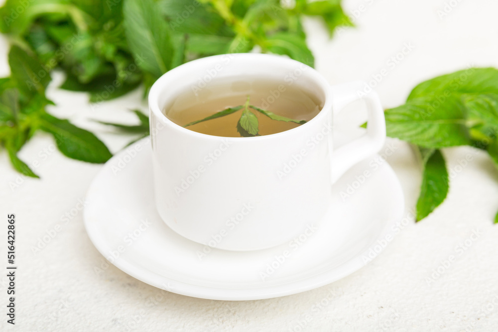 Cup of mint tea on table background. Green tea with fresh mint top view with copy space Cup of mint tea on table background. Green tea with fresh mint top view with copy space