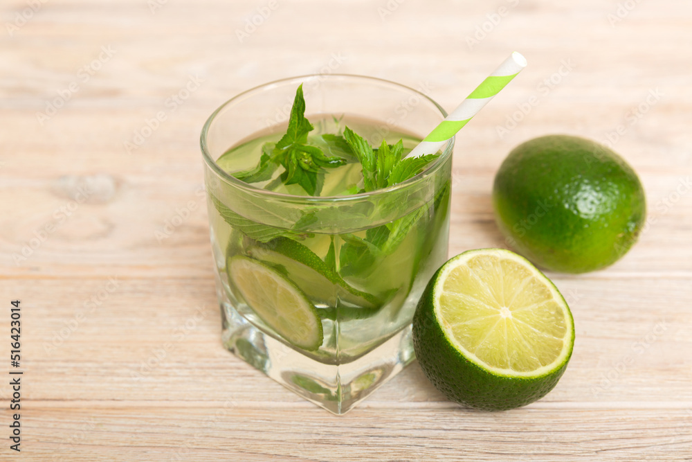 Mojito cocktail. Refreshing mojito cocktail with lime, lemon and mint in a tall glass with a stick Mojito cocktail. Refreshing mojito cocktail with lime, lemon and mint in a tall glass with a stick