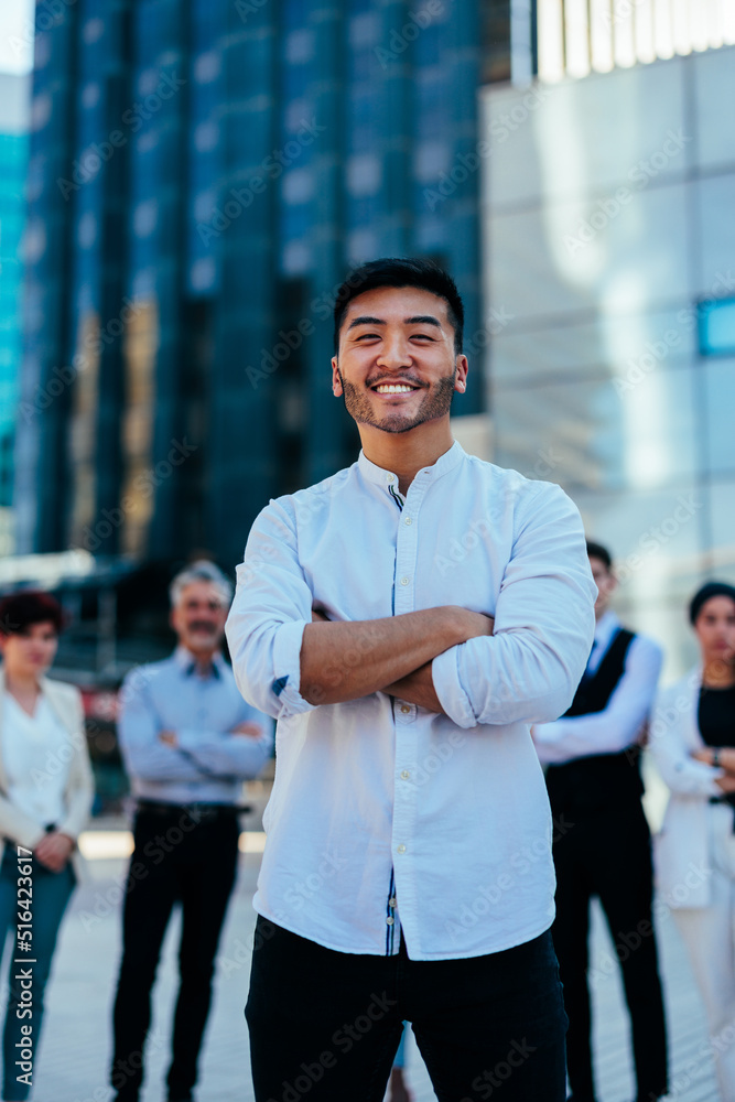 Confident Asian businessman in city Confident Asian businessman in city