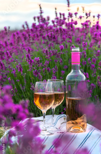 Wine in a lavender field. Selective focus.