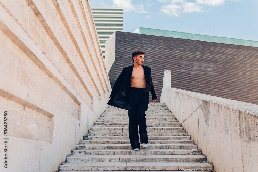 Man with jacket on naked torso walking downstairs Man with jacket on naked torso walking downstairs