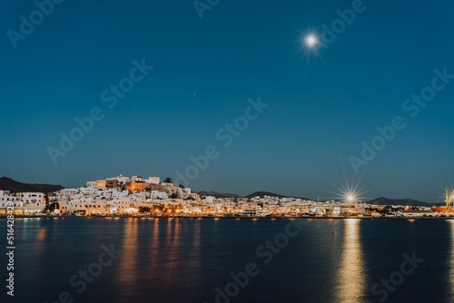 Fototapeta Summer night on the beautiful Greek island of Naxos and Lights reflecting in wat