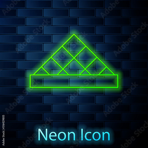 Glowing neon line Louvre glass pyramid icon isolated on brick wall background. Louvre museum. Vector