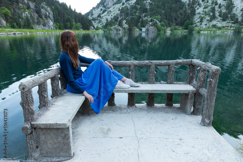 Woman contemplating the Ibon (lake) of the Panticosa Baths in the Tena Valley in the Spanish Pyrenees. photo