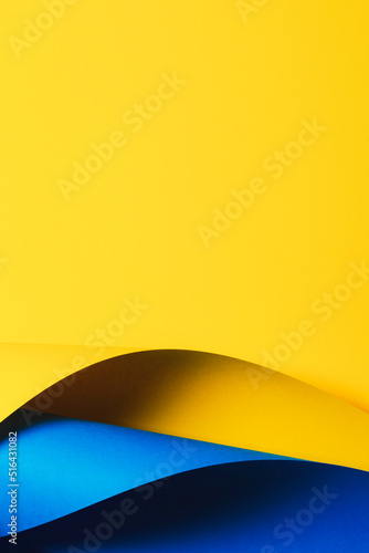 Abstract wave of yellow and light blue paper. Creative geometric curved paper with light and shadows. Abstract geometry background with copy space