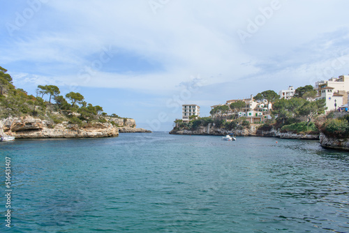 Coastal cliffs  boat and yacht in bay of Cala Figuera