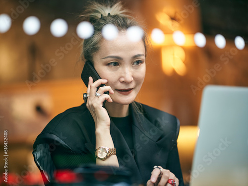 Photography mid adult asian businesswoman working in coffee shop