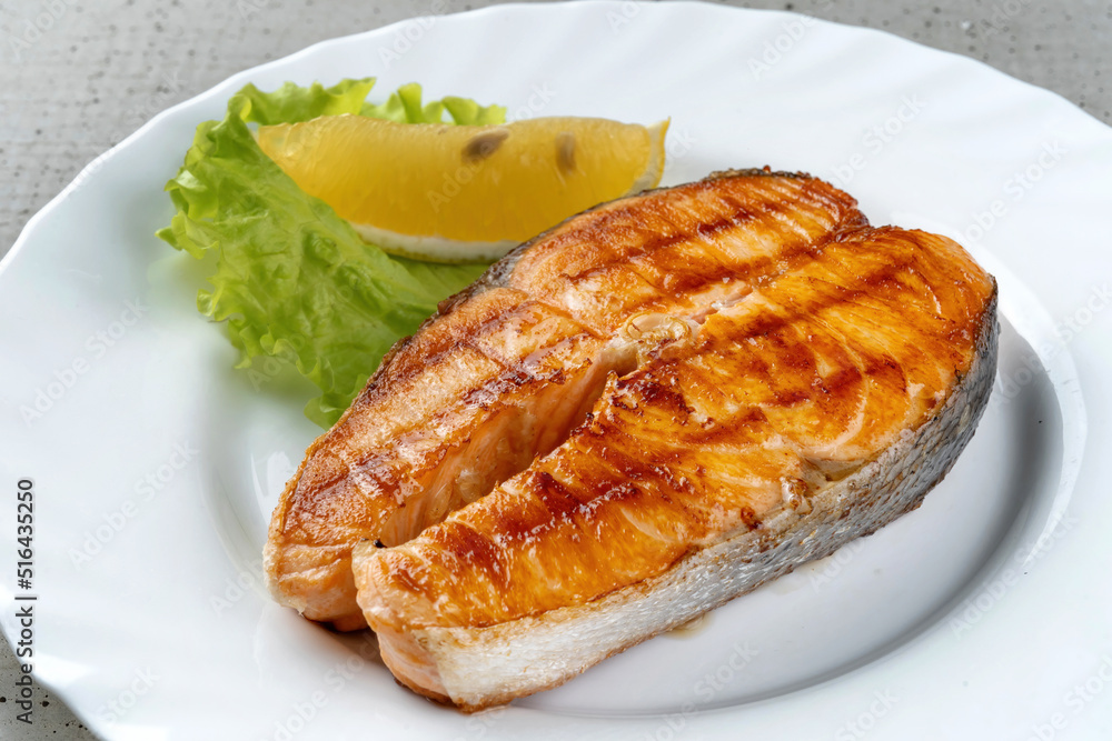 Salmon teriyaki steak with lemon and lettuce. Salmon teriyaki steak with lemon and lettuce.