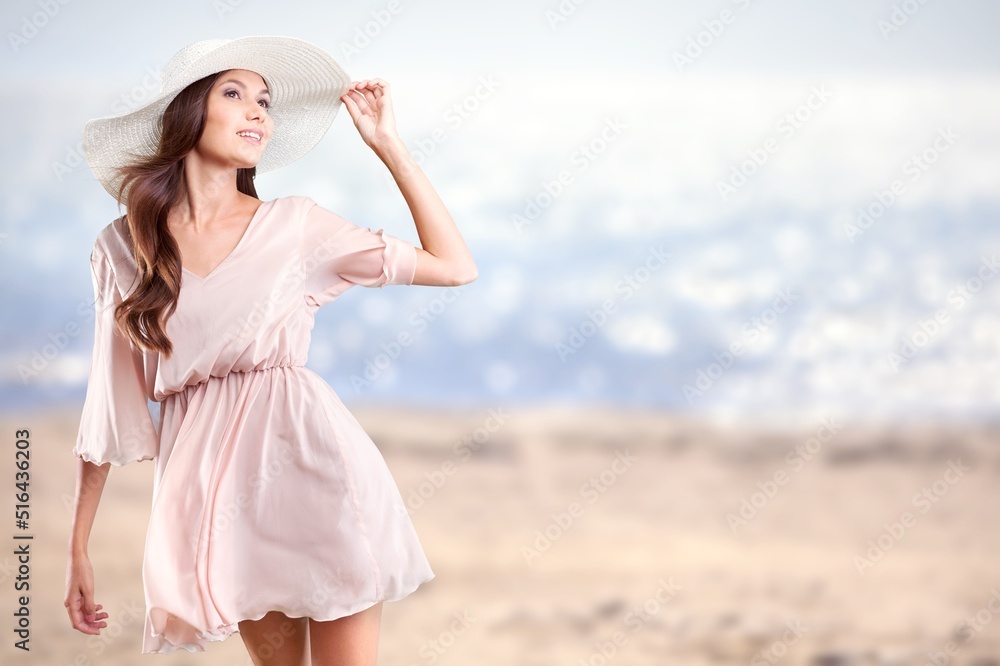 Luxury beach vacation elegant tourist woman walking relaxing at the beach. Lady tourist on holiday vacation resort
