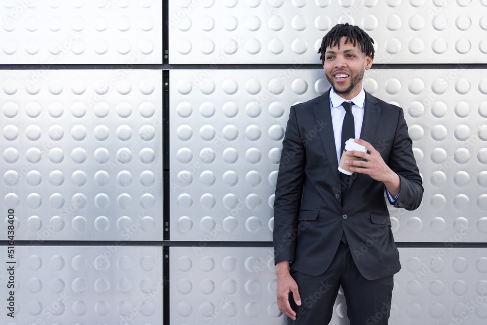 man in suit drinking coffee at silver wall man in suit drinking coffee at silver wall