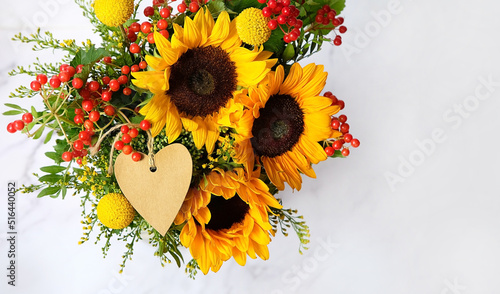 Photography Beautiful autumn bouquet with heart card on abstract light grey background