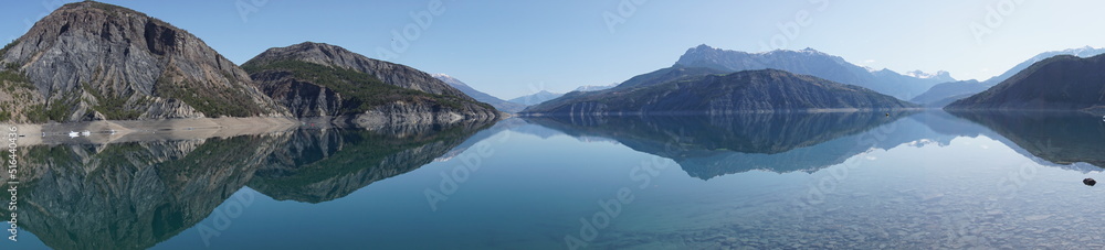 panoramic view of lake serre ponçon alps france with perfect mirror reflection of the mountains