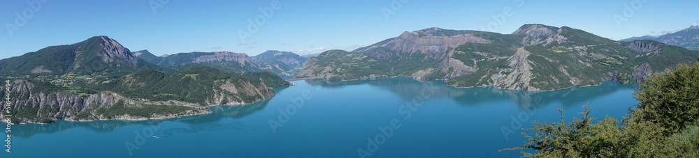panoramic view of serre ponçon lake  and the mountains of the alps france 