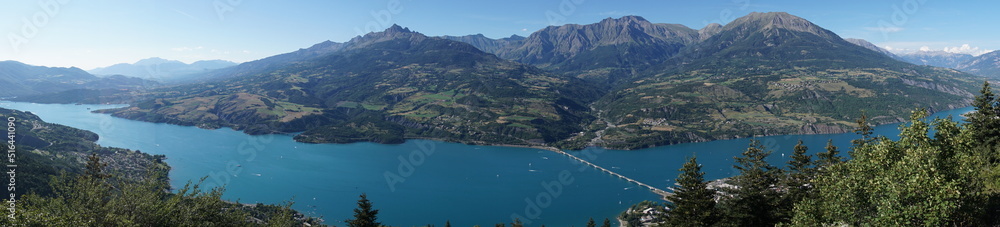 panoramic view of the mountains of the alps france and serre ponçon lake with bridge