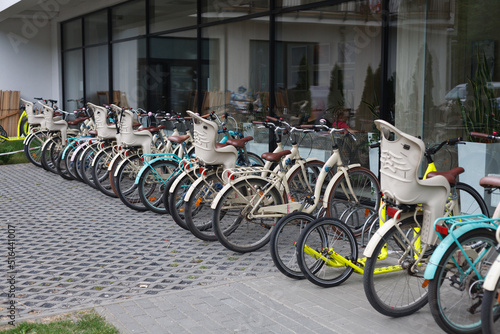 Hotel bike rental - a number of bikes standing in front of the building