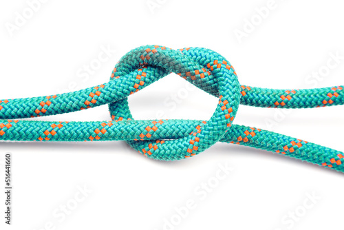 durable colored rope for climbing equipment on a white background. knot of braided cable. item for tourism and travel